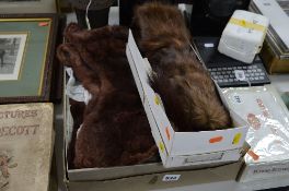 TWO BOXED FUR STOLES AND A CAST FINIAL (?) height approximately 16cm (3)