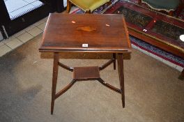 AN EDWARDIAN MAHOGANY AND INLAID FOLD OVER CARD TABLE, with shell inlay detail on square tapering