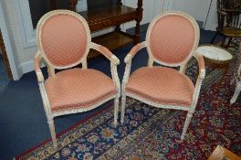 A PAIR OF FRENCH PINK UPHOLSTERED ARMCHAIRS, on fluted legs