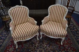 A PAIR OF FRENCH PAINTED ARMCHAIRS, covered with red and cream striped upholstery