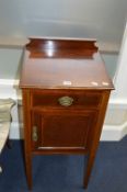 AN EDWARDIAN MAHOGANY AND INLAID POT CUPBOARD, with a raised back, single drawer on square