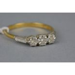 A LATE 20TH CENTURY 18CT GOLD THREE STONE DIAMOND RING, eight cut diamonds illusion set, estimated