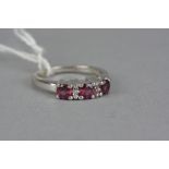 A GARNET AND ZUBIC ZIRCONIA RING, ring size N1/2, stamped '925'