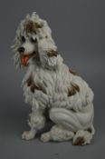 AN ALGORA PORCELAIN FIGURE OF A SEATED DOG, approximate height 34cm