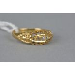 AN EARLY 20TH CENTURY 18CT GOLD DIAMOND FIVE STONE HALF HOOP RING, estimated total old European