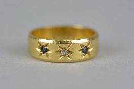 A LATE 20TH CENTURY 18CT GOLD SAPPHIRE AND DIAMOND THREE STONE GYPSY SET BAND RING, diamond weight