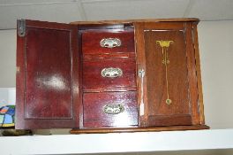 AN ARTS AND CRAFTS STYLE MAHOGANY SMOKER'S CABINET, printed decoration to the doors, fitted with