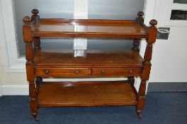 A VICTORIAN MAHOGANY THREE TIER BUFFET, the central shelf with two long drawers, on ceramic casters,