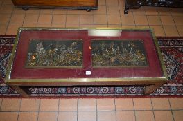 A MAHOGANY BRASS BANDED COFFEE TABLE, with two medieval plaques of knights on a horse behind a glass