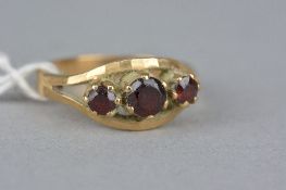 A LATE 20TH CENTURY THREE STONE GARNET RING, ring size O, hallmarked 9ct gold, approximate gross