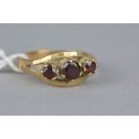 A LATE 20TH CENTURY THREE STONE GARNET RING, ring size O, hallmarked 9ct gold, approximate gross