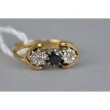 A MID TO LATE 20TH CENTURY GOLD SAPPHIRE AND DIAMOND RING, two eight cut diamonds illusion set,