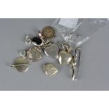 A BAG OF MIXED SILVER PENDANTS, lockets, etc