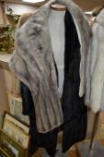 A BLACK LONG FUR COAT, a light brown fur jacket and a grey stole (no labels or sizes) (3)