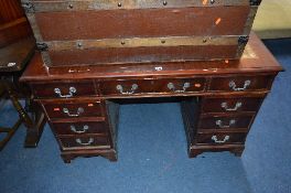 A MODERN MAHOGANY PEDESTAL DESK, with tan tooled leather inlay top, and nine various drawers,