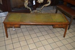 A LONG REPRODUCTION MAHOGHANY COFFEE TABLE, with green tooled leather inlay top and two short