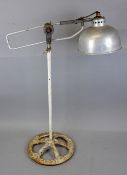 DUO-RAY FLOOR STANDING ADJUSTABLE LAMP, with a galvanised domed shade on a painted cast iron base