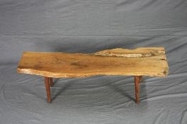 A NATURLISTIC YEW WOOD COFFEE TABLE, on four tapering legs, approximate width 139cm