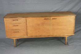 ALFRED COX TEAK MID 20TH CENTURY SIDEBOARD, flanked by three graduated drawers beside double