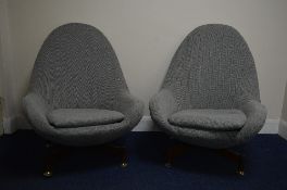 A PAIR OF GREAVES & THOMAS SWIVEL EGG CHAIRS, recently re-upholstered in grey weave on a teak 'X'