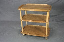 A BLONDE ERCOL ELM THREE TIER TEA TROLLEY, with galleried top, approximate size width 68cm x