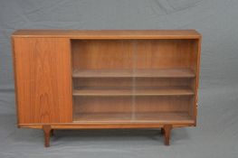 A MCINTOSH & CO LTD, TEAK BOOKCASE, with glazed sliding doors beside a single cupboard door,