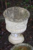 A MODERN COMPOSITE URN ON STAND, with floral motifs, 46cm in diameter, 63cm high