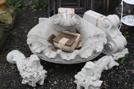 A RECONSTITUTED STONE SHELL SHAPED WATER FEATURE, with two Japanese fish and two stands