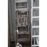 A SET OF ALUMINIUM EXTENSION LADDERS, 300cm long, an aluminium step ladder, 210cm long and a