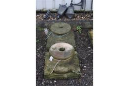 A PAIR OF SANDSTONE COLUMN BASES/TOPS, with foliage corners, 46cm square at base, 28cm diameter at