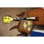 A RYOBI POWR LT2 KBC305CSB PETROL STRING TRIMMER AND BUSH CUTTER