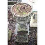 A CAST IRON CAMPANA URN, on square column base, standing 110cm high x 45cm diameter, urn top