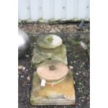 A PAIR OF SANDSTONE COLUMN BASES/TOPS, with foliage corners, 46cm square at base, 28cm diameter at