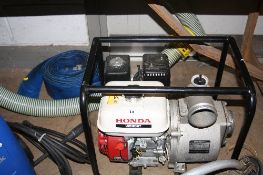 A HONDA WB30XT WATER PUMP, with inlet and outlet pipes