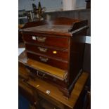 AN EDWARDIAN MAHOGANY FOUR DRAWER MUSIC CABINET, with brass handles and gallery top, approximate