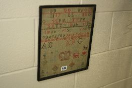A 19TH CENTURY NEEDLEWORK SAMPLER, cotton on a coarse linen ground, with alphabets, numbers,