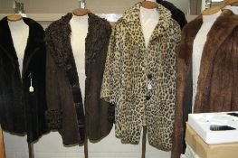 A LONG FUR COAT, a short sheepskin jacket and three other faux fur coats (5)