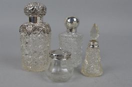 FOUR SILVER TOPPED GLASS COSMETIC JARS