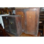 TWO EARLY 20TH CENTURY HANGING TWO DOOR CUPBOARDS, one with panelled doors, the other with glazed