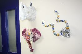 THREE NOVELTY WALL HANGINGS, shaped as a set of horns (covered in wrapping), a paper mache Rhino