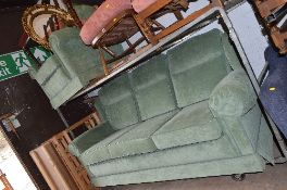 A GREEN UPHOLSTERED TWO PIECE LOUNGE SUITE