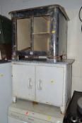 A METAL TWO DOOR CABINET WITH AN ENAMEL TOP and a small steel two door cabinet (2)