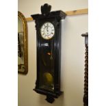 A BLACK PAINTED WALL CLOCK, (sd) (one weight and pendulum)