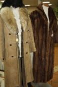 A LONG FUR COAT, a long sheepskin coat and a faux fur stole (?)