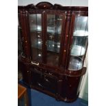 A LARGE MODERN SERPENTINE FRONTED DISPLAY CABINET, with four glazed doors over four doors and two