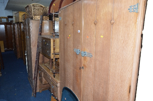 AN OAK FOUR PIECE BEDROOM SUITE, comprising of a two door wardrobe, smaller two door wardrobe,