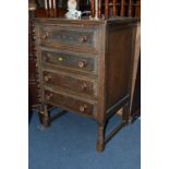 AN OAK CHEST OF FOUR DRAWERS