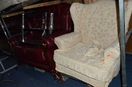 A BURGUNDY LEATHER TWO SEATER SETTEE, and an upholstered wing back armchair (2)