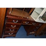 A MODERN MAHOGANY PEDESTAL DESK, with tan tooled leather inlay top, and nine various drawers,