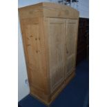 A PINE PANELLED TWO DOOR WARDROBE, approximate size width 139cm x height 197.5cm x depth 60cm